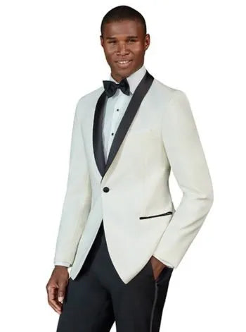 African American man wearing an ivory tuxedo with black lapels with black tuxedo pants on a white background