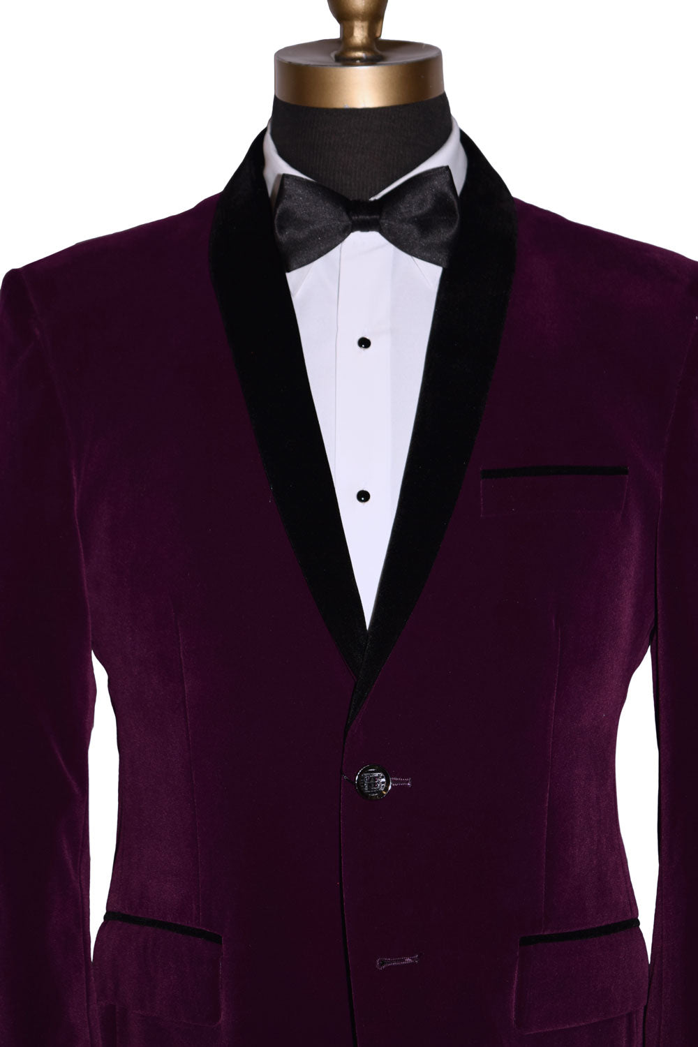 Purple velvet tuxedo jacket with black lapels on a mannequin wearing a white tuxedo shirt and black satin bowtie against a white background