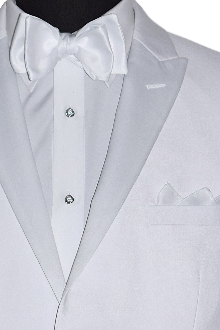 very close up white peak lapel tuxedo wearing a white "tie-yourself"  bow tie with cubic zirconia formal jewelry and pocket square on a white background