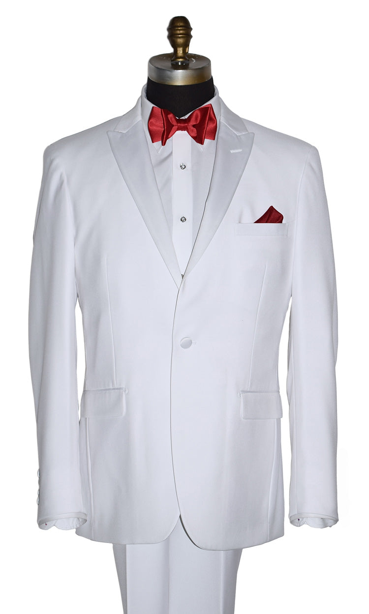 close-up life size mannequin wearing white peak lapel tuxedo with red bow tie and pocket square on a white background
