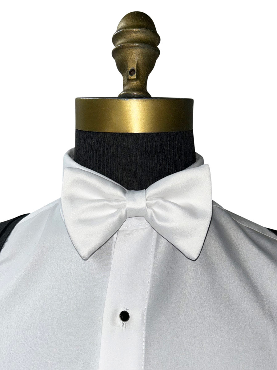 White bow tie on a mannequin with a white shirt and black suspenders