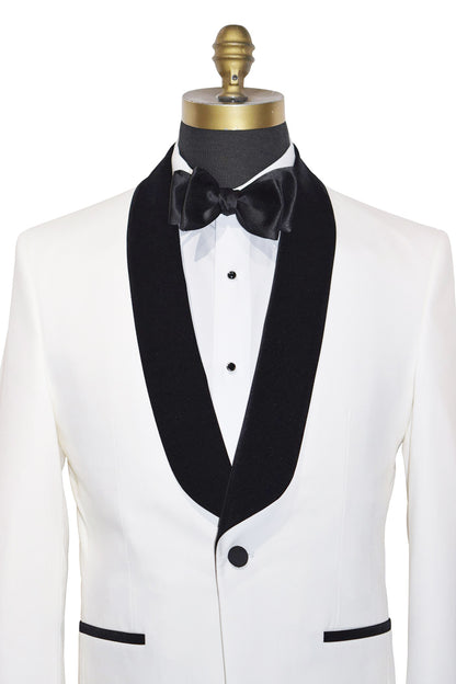 very close front of a tuxedo with black velvet shawl collar lapels and bow tie on a mannequin against a white background