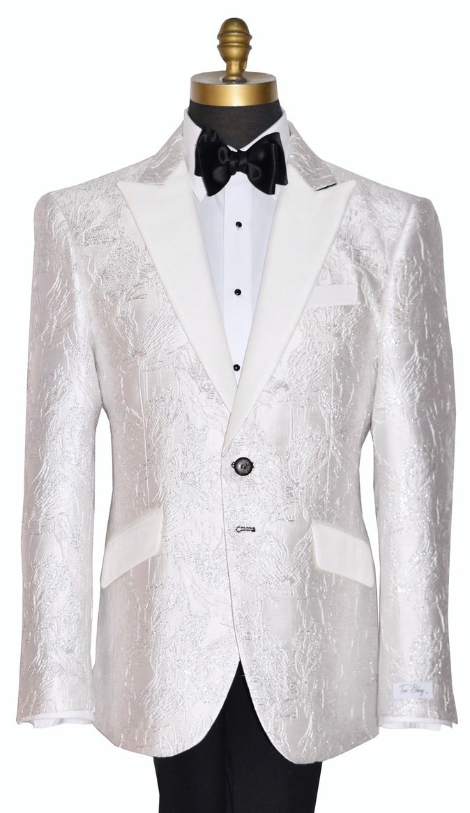 White peak lapel tuxedo with silver highlights on a mannequin with a black bow tie against a white background