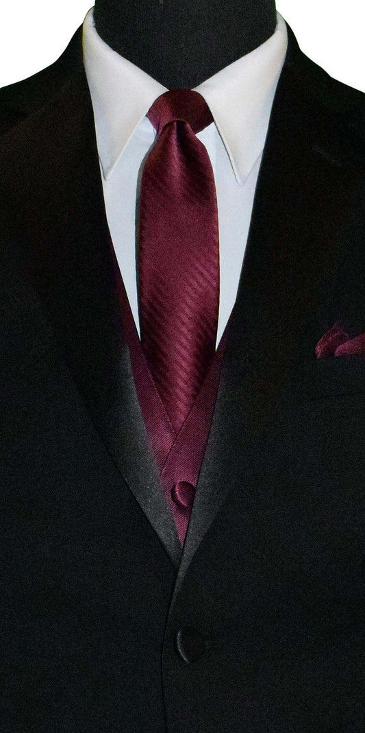 close-up mens black suit with a wine necktie with subtle wine stripe against a white background