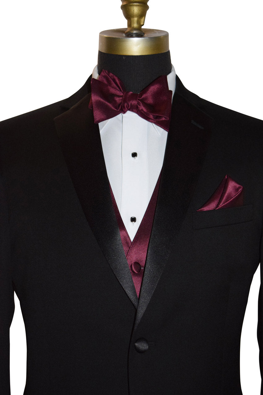 close-up front view Black tuxedo with a wine "tie-yourself" bow tie and pocket square on a mannequin against a white background.